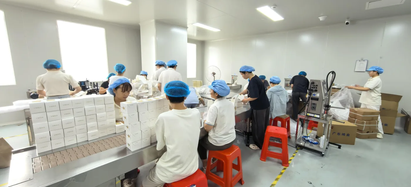 Factory team completing perfume packaging assembly